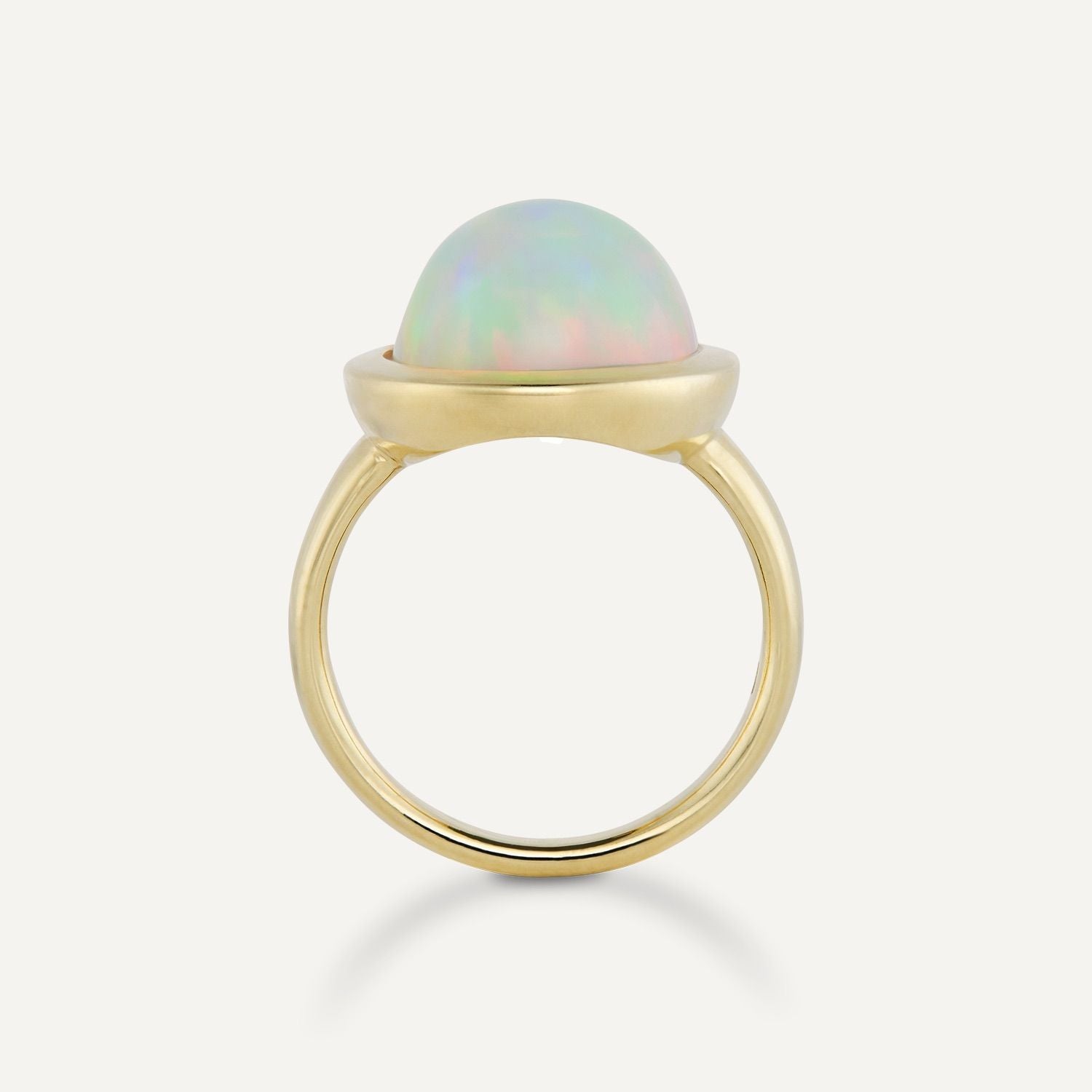 Seitenansicht eines goldener Rings mit einem großen, ovalen, bläulich schimmernden Opal; der Opal ragt rund aus dem Ring heraus;