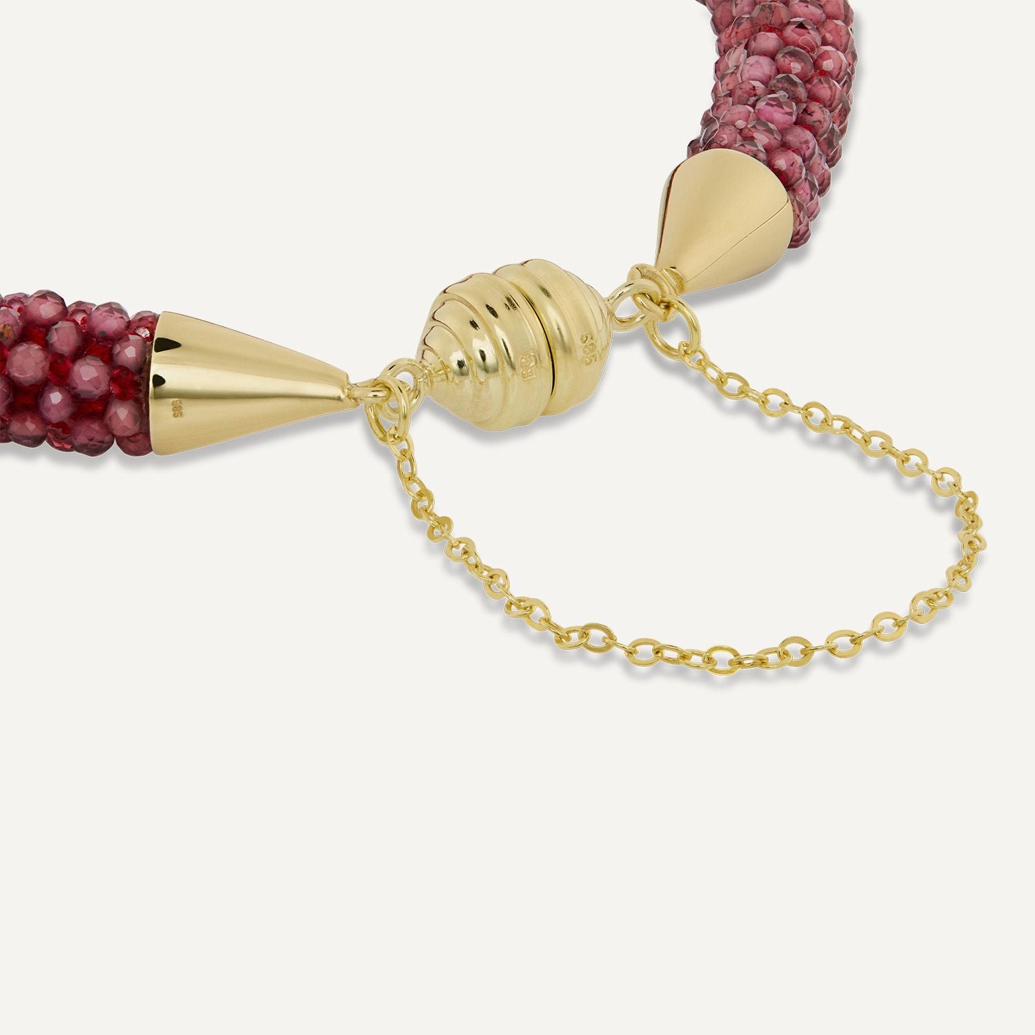 Ausschnitt des Magnetverschlusses mit Sicherheitskettchen eines Armbands aus vielen kleinen Rubin-Steinen in dunkelrot;